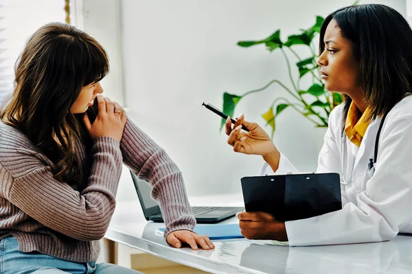 Woman talking to a female physician