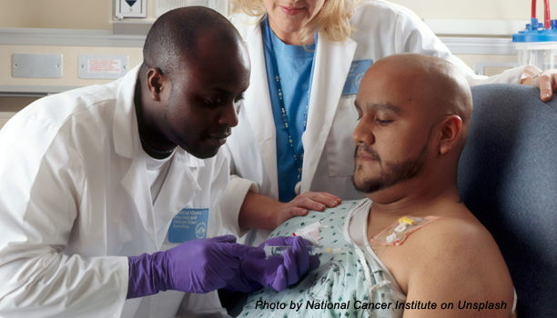Doctor administering drug to patient through tube
