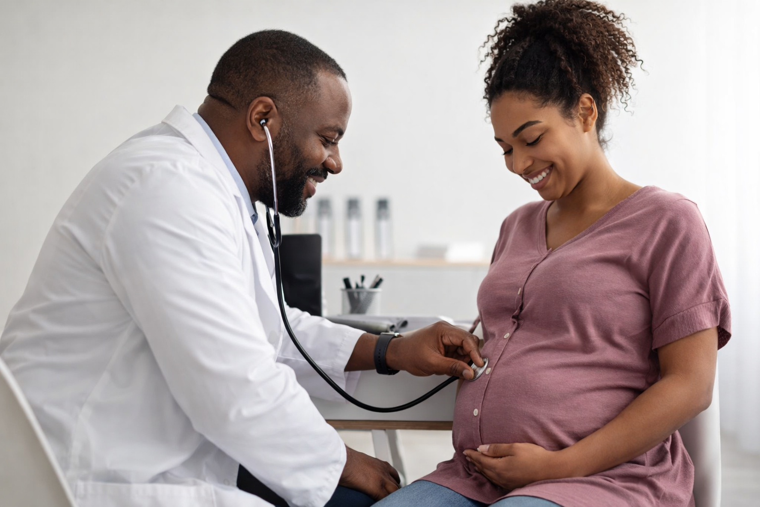 Male doctor examines child in mothers lap